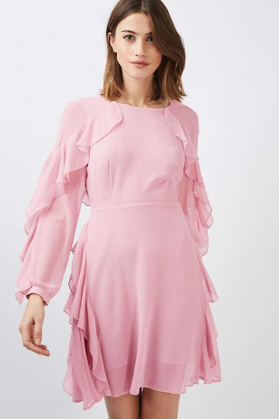 woman wearing a light pink frilly dress
