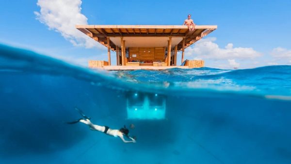 The Tanzania underwater hotel room and someone doing snorkeling near the room